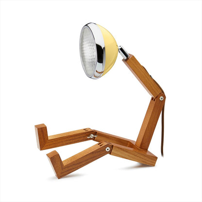 Störtskön bordslampa i form av en figur med ben och en lampa som huvud. Färg: Light Yellow.